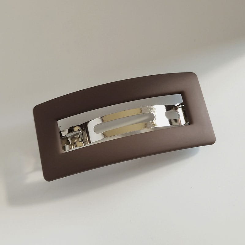Matte brown rectangular hair clip with silver metal detail