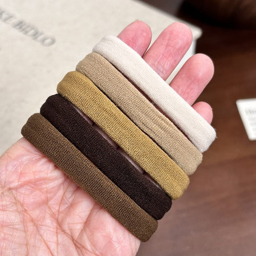 Soft fabric hair ties in cream, beige, mustard and brown tones